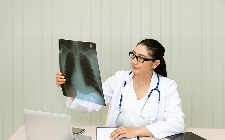 Medical doctor examine x-ray film